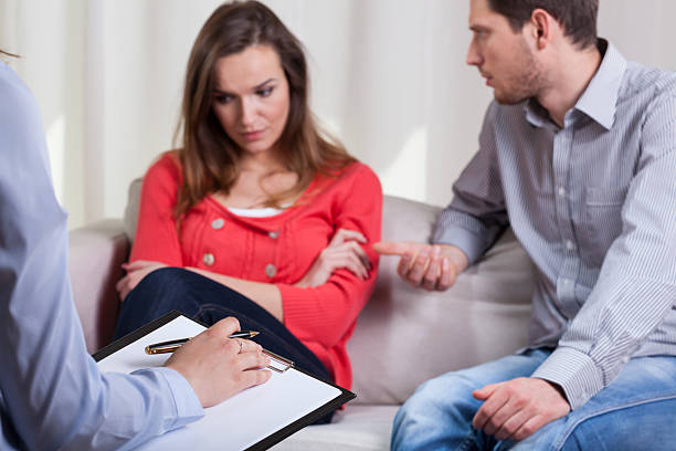 Counselor leading couple through focused communication and conflict resolution discussion