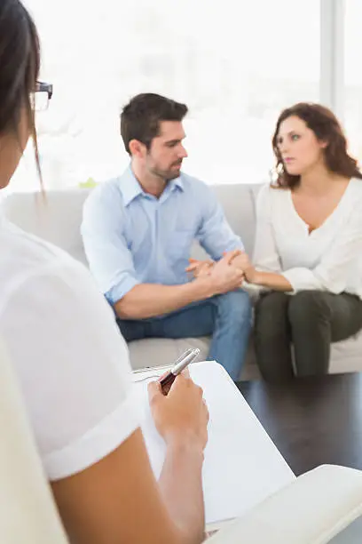 Couple in counseling session discussing communication goals before marriage and future planning